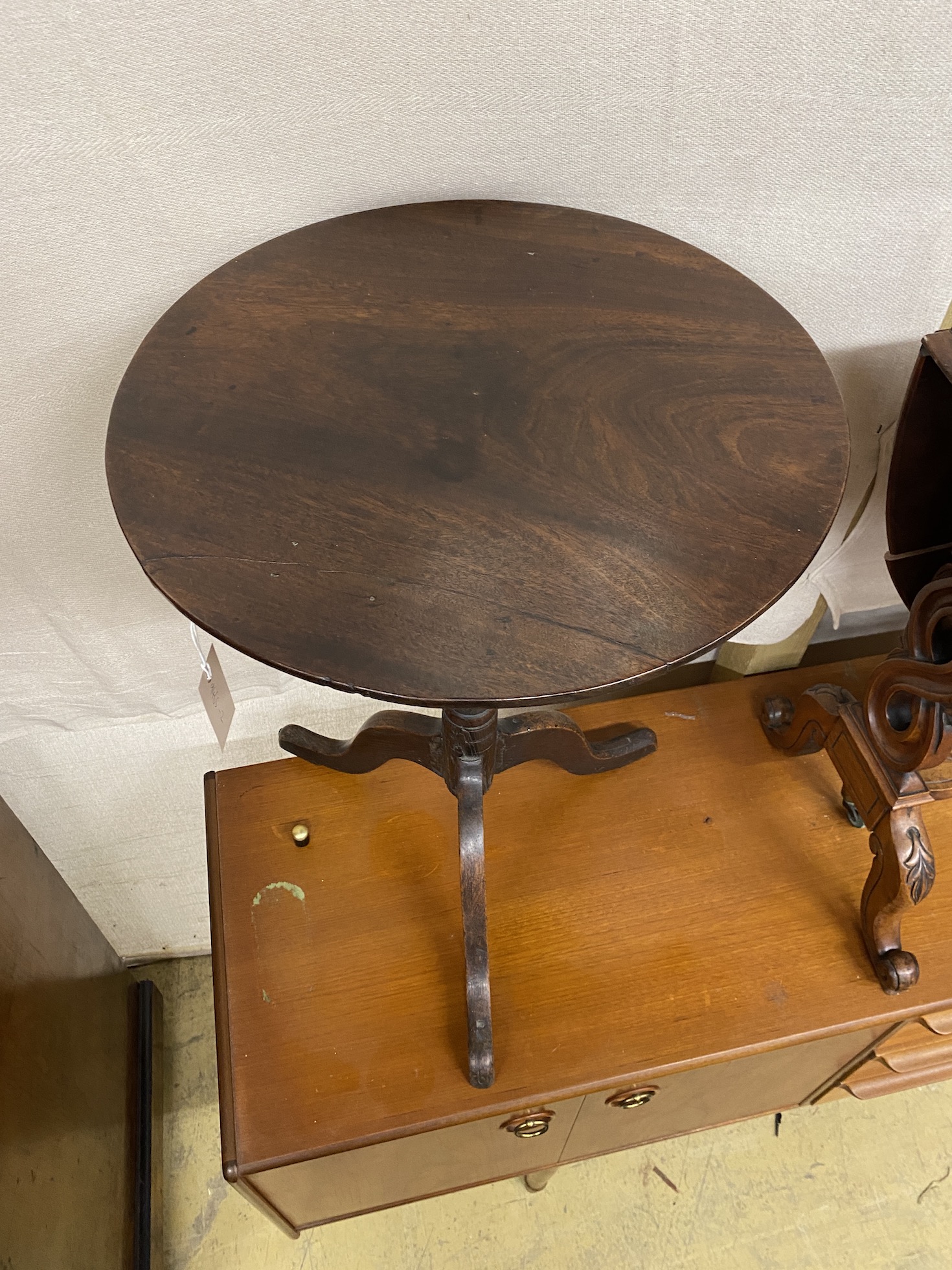 A George III provincial circular oak tripod tea table, diameter 48cm, height 66cm